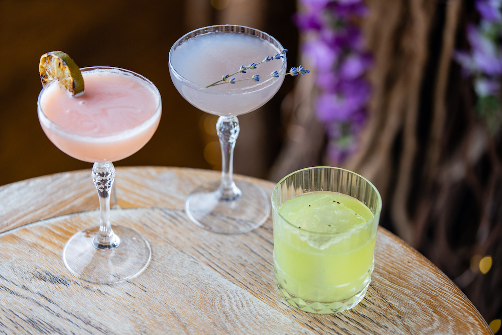 picture of three cocktails on the edge of a table